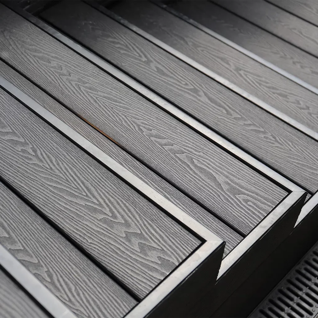 Close-up of dark grey wood-grain composite flooring, showing realistic texture.