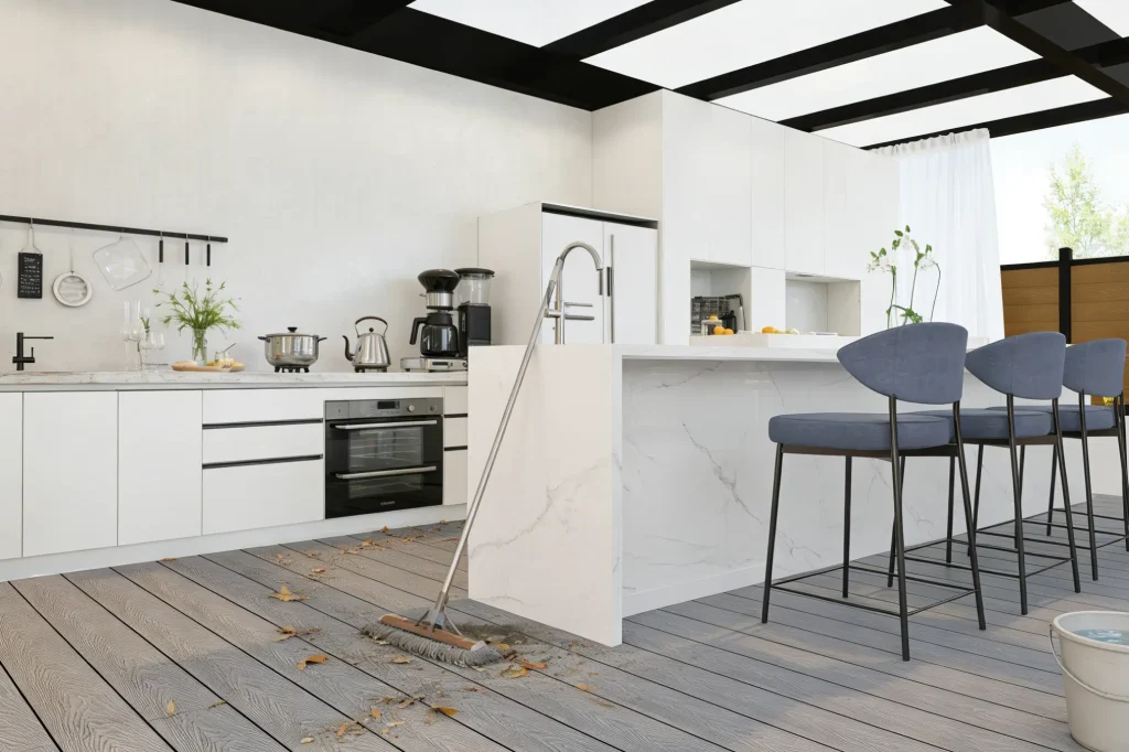 Grey wood-look WPC decking in a semi-outdoor kitchen terrace—highlighting hassle-free cleanup of fallen leaves and everyday messes.