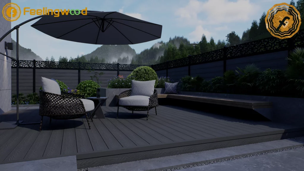 A serene luxury backyard patio featuring Feelingwood dark grey WPC composite decking and matching fencing with decorative black metal trim. The space includes wicker outdoor furniture, a cantilever umbrella, and lush greenery, set against a misty mountain landscape, showcasing modern, low-maintenance outdoor living.