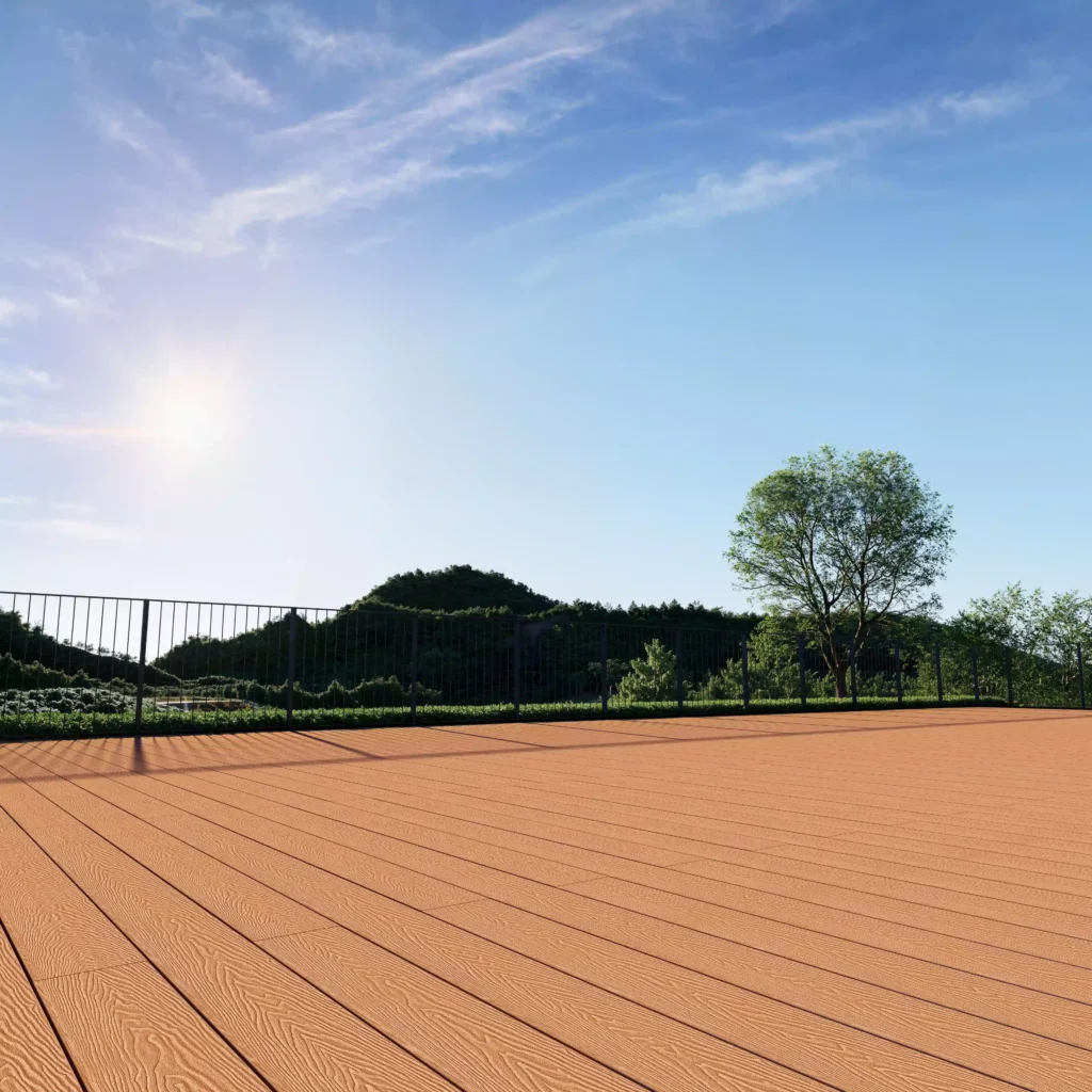 Spacious rooftop patio featuring warm terracotta-colored WPC composite decking with realistic wood grain texture. The deck overlooks lush green hills and a clear blue sky, with a black metal railing and a single tree, showcasing a serene outdoor living space ideal for residential properties.