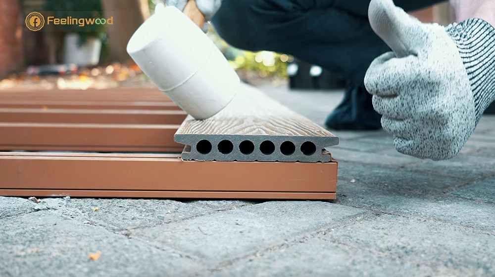 How to Build a Floating Deck - Put the first board onto the joists